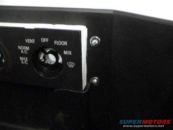 Close-up of car climate controls with labels for VENT, OFF, FLOOR, NORM A/C, MAX A/C, and MIX