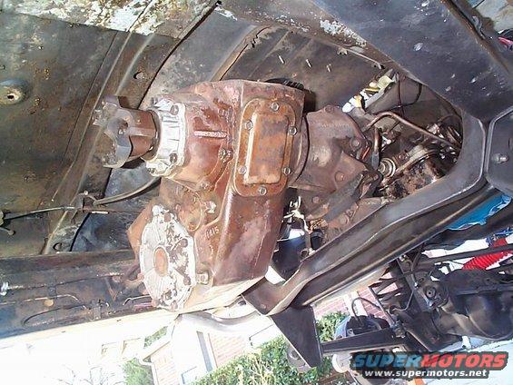 Underside view of a vehicle's transfer case and driveshaft connections