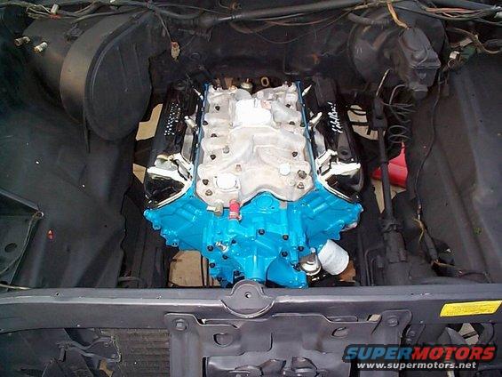 Engine with blue block and chrome valve covers in engine bay