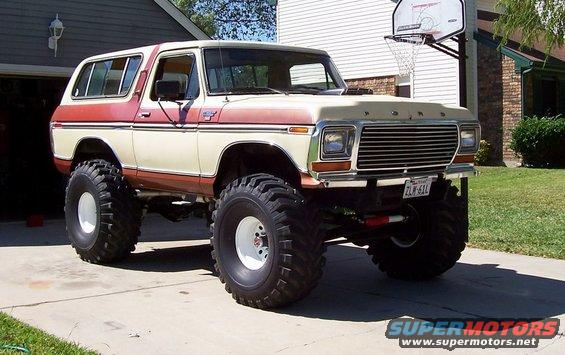 Lifted 1979 Ford Bronco, cream and red two-tone, with large off-road tires