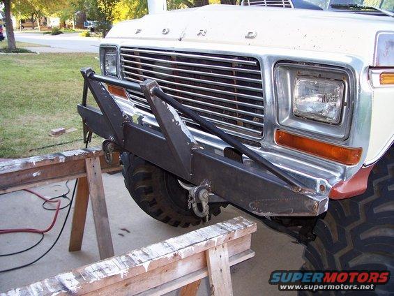 1979 Ford Bronco front end with custom bumper installed, vehicle on sawhorses