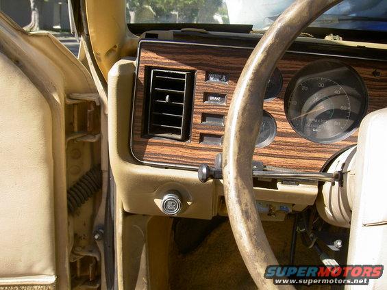 1982 Ford Mustang interior showing dashboard with wood grain trim, air vent, and speedometer