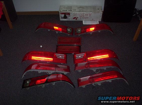 Several red car tail lights laid out on a carpeted floor