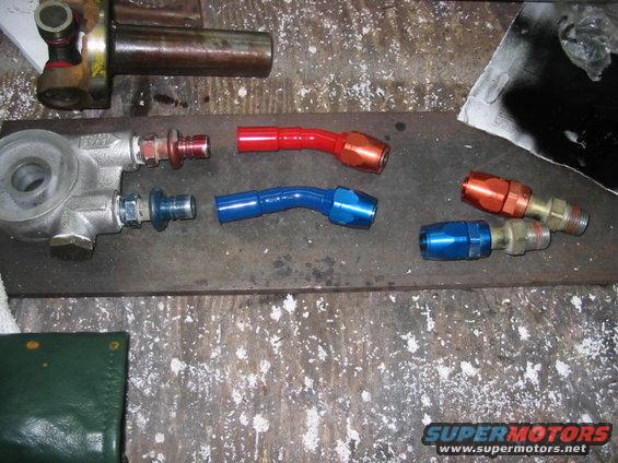 oil filter housing and assorted AN fittings in red, blue, and orange