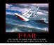 2001 Ford Crown Victoria - A sailboat struggles against a massive wave, illustrating the power and danger of the sea.