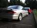 1994 Ford Probe - Two coupes, a silver 1994 Ford Probe and a red car, are parked on an asphalt surface.
