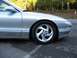 1994 Ford Probe - The front quarter panel and wheel of a silver 1994 Ford Probe GT are visible in this image.