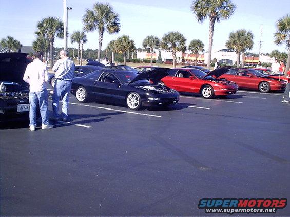 Black 1995 Ford Probe with hood open, parked in a lot
