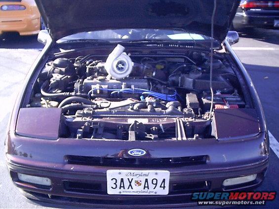 1995 Ford Probe engine bay showing turbocharger installation. Maryland license plate 3AX A94