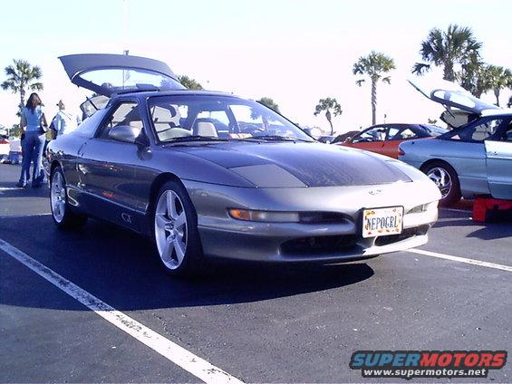 Gray 1995 Ford Probe with hood and trunk open, parked in a lot