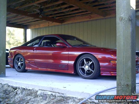 Red 1995 Ford Probe GT coupe, side view