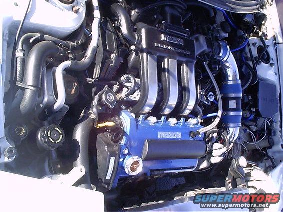 Mazda engine with blue valve cover and chrome intake manifold