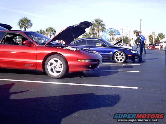 Red 1995 Ford Probe GT in foreground, blue 1995 Ford Probe in background, both with hoods open