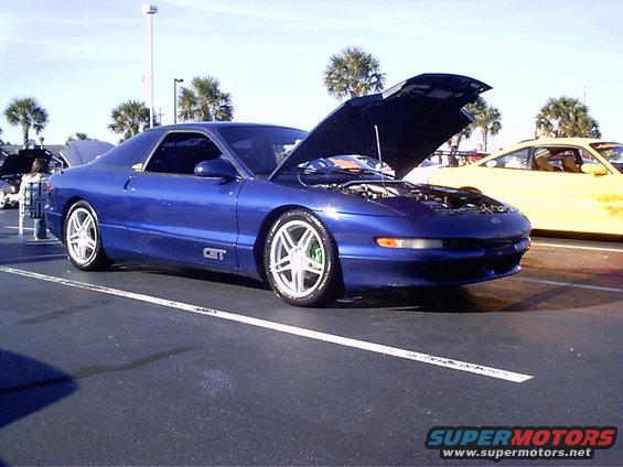 Blue 1995 Ford Probe with hood open, GT badge visible