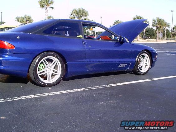 Blue 1995 Ford Probe GT with hood open, parked on asphalt