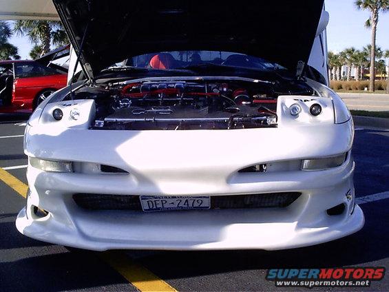 White 1995 Ford Probe with hood open, showing engine and red interior, front view