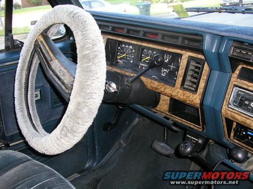 1986 Ford Bronco interior showing dashboard, steering wheel with cover, and gear shifter