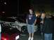 1996 Ford Probe - A white 1996 Ford Probe with custom tribal graphics is parked next to a red car at night.