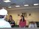 1996 Ford Probe - A group of people are standing in a room with framed artwork on the wall.