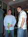 1996 Ford Probe - Two men are standing indoors, one holding a large green novelty drink container.