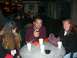 1996 Ford Probe - Several people are gathered around a table, some with drinks, in an outdoor setting at night.