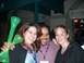1996 Ford Probe - Three friends share a happy moment, with one person holding up two green novelty horns.