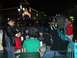 1996 Ford Probe - People socialize at outdoor tables in front of a lit building at night.
