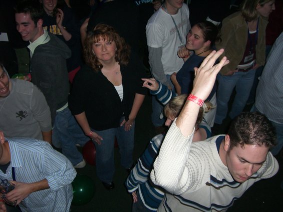 People dancing at a party, some wearing wristbands