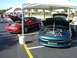 1996 Ford Probe - Two Ford Probes are displayed under tents at an outdoor event.
