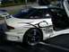 1996 Ford Probe - This heavily modified white coupe features butterfly doors and prominent racing decals, including the word 'PROBE' on its side.