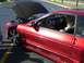 1996 Ford Probe - Customized 1996 Ford Probe with aftermarket wheels and a woman inside.