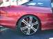 1996 Ford Probe - Close-up of a red car's rear side, showing a custom wheel and brake caliper.