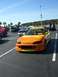 1996 Ford Probe - A customized sports car with a flame paint job is parked in a lot during a car show.