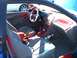 1996 Ford Probe - The interior of a car features extensive red trim and a fire extinguisher mounted near the passenger seat.