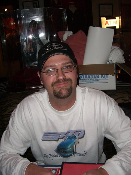 Man in white t-shirt with blue car graphic and "PRO" logo