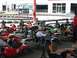 1996 Ford Probe - Several go-karts are parked in a line at a track, with people seated in some of them, ready to race.