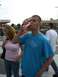 1996 Ford Probe - A man drinks a Coca-Cola while standing at a NASCAR track with other people in the background.