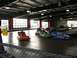 1996 Ford Probe - People are enjoying bumper cars on an indoor track with multiple cars in motion.