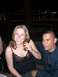 1996 Ford Probe - Two people are seated at a table outdoors at night, with a blurred background of city lights.