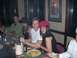 1996 Ford Probe - A group of people are gathered around a table, enjoying a meal together in a restaurant setting.