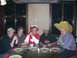 1996 Ford Probe - A group of friends are seated at a table, some wearing novelty hats, in what appears to be a restaurant.