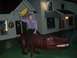 1996 Ford Probe - Man rides a dinosaur statue outside a store at night.