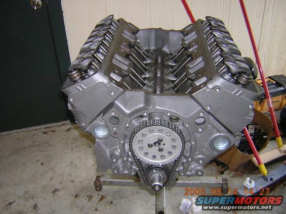 V8 engine block on stand, showing timing chain and gears