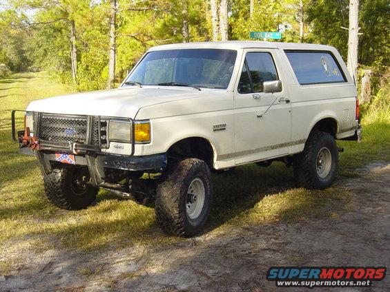 White Ford Bronco with aftermarket grille guard and Confederate flag decal
