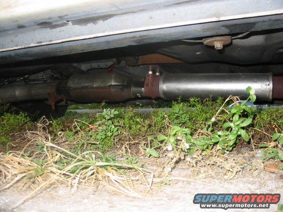 Underside view of a car's exhaust pipe and catalytic converter