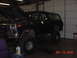 1978 Ford Bronco - This 1978 Ford Bronco is parked inside a garage with its hood open, showing off its large tires.