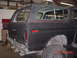 1978 Ford Bronco - Rear view of a 1978 Ford Bronco in a garage, showing the quarter panel and bumper.