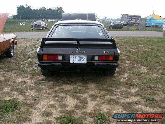 Rear view of a black Ford Capri with a spoiler and Ontario license plate '75 JPS'
