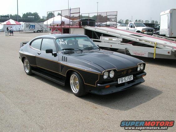 Black coupe with gold trim and gold wheels, front license plate FB-EJ587