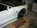1996 Ford Probe - A white sports coupe is parked in a garage next to a box containing new suspension components.